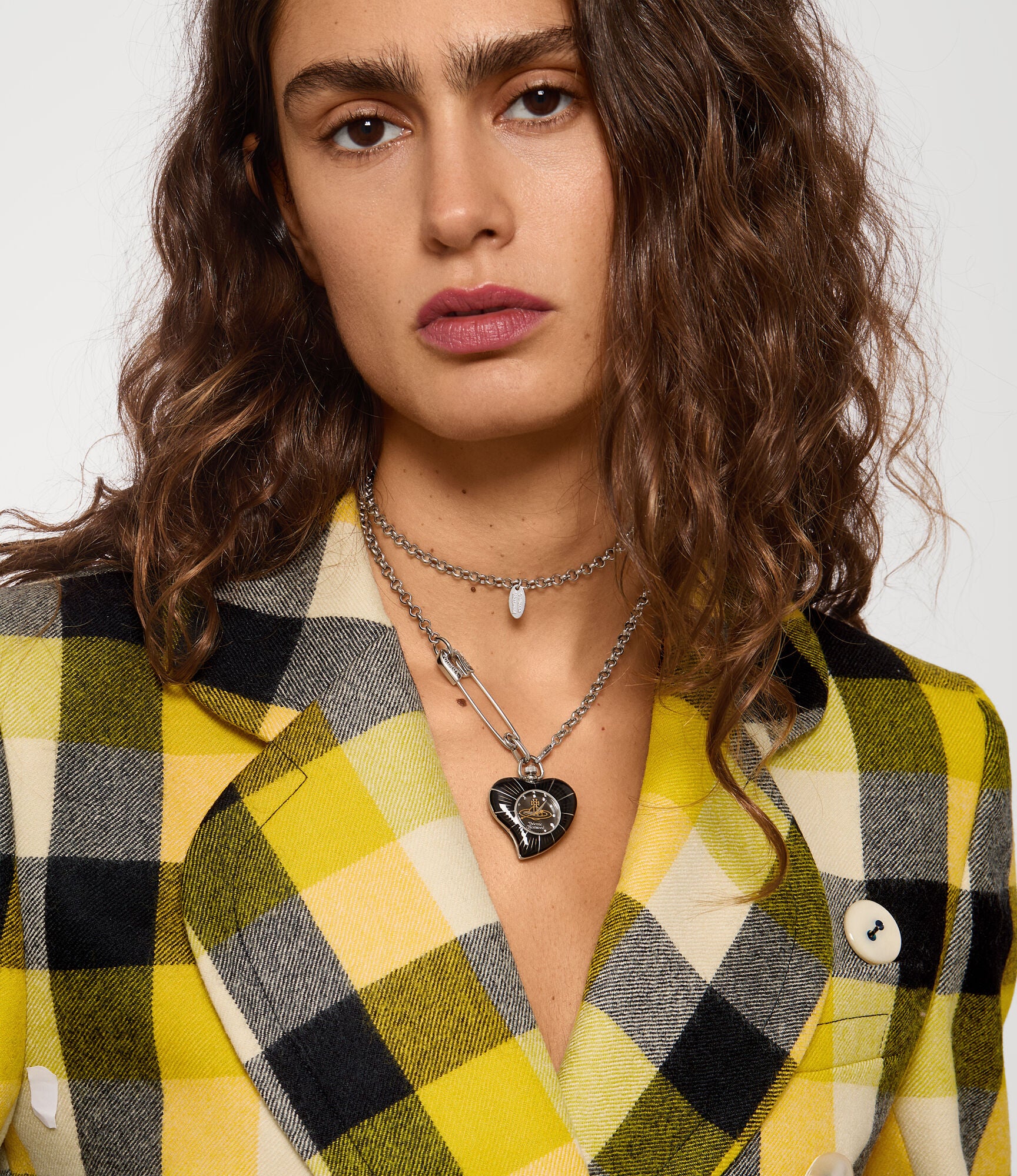 Vivienne Westwood Heart Pendant women's watch with a black dial and silver pendant chain. Close-up detail view.