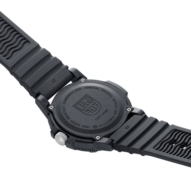 Back of a black wristwatch with a textured rubber strap.