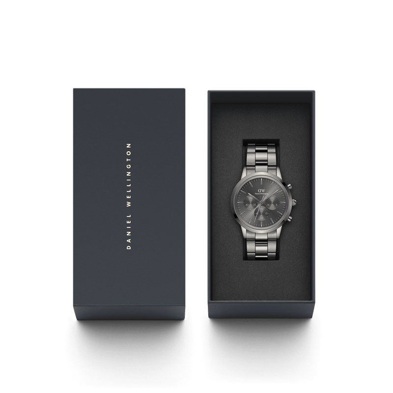 Sleek silver chronograph wristwatch in a dark presentation box.