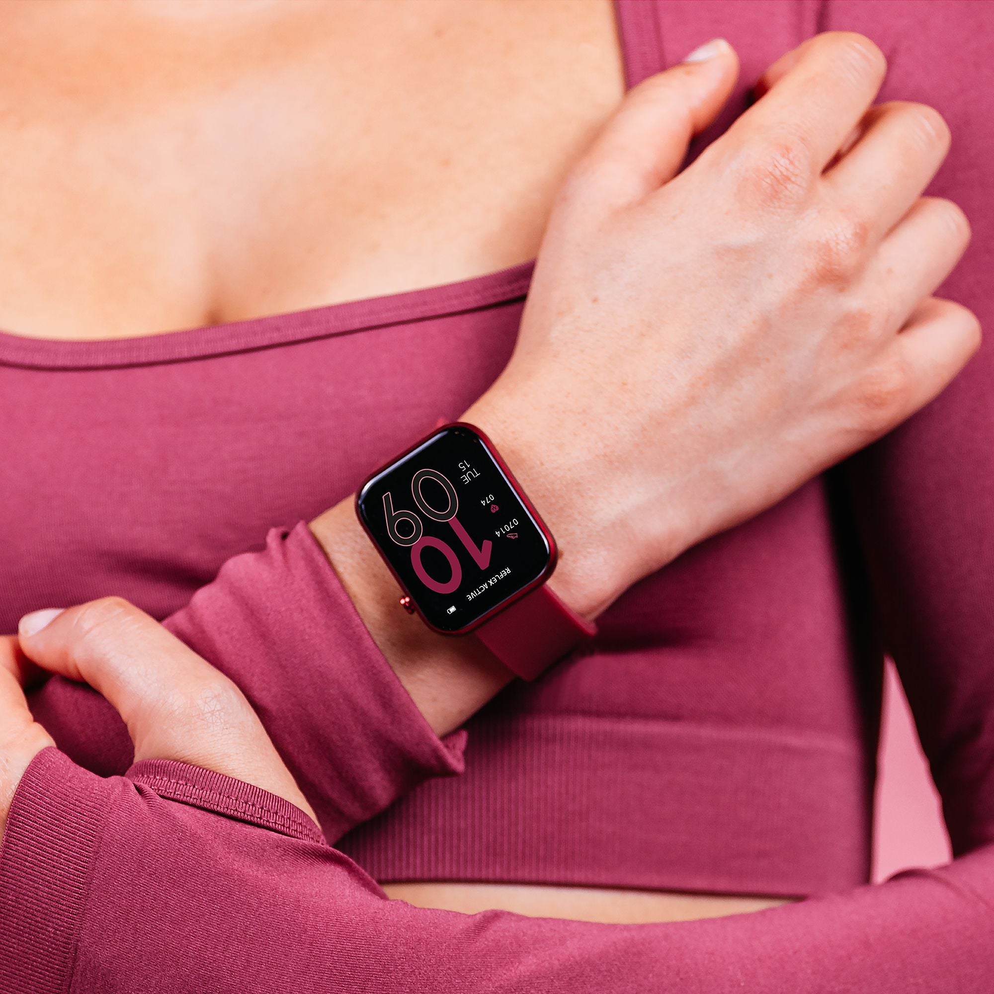 Smartwatch displaying time and heart rate on a person’s wrist.