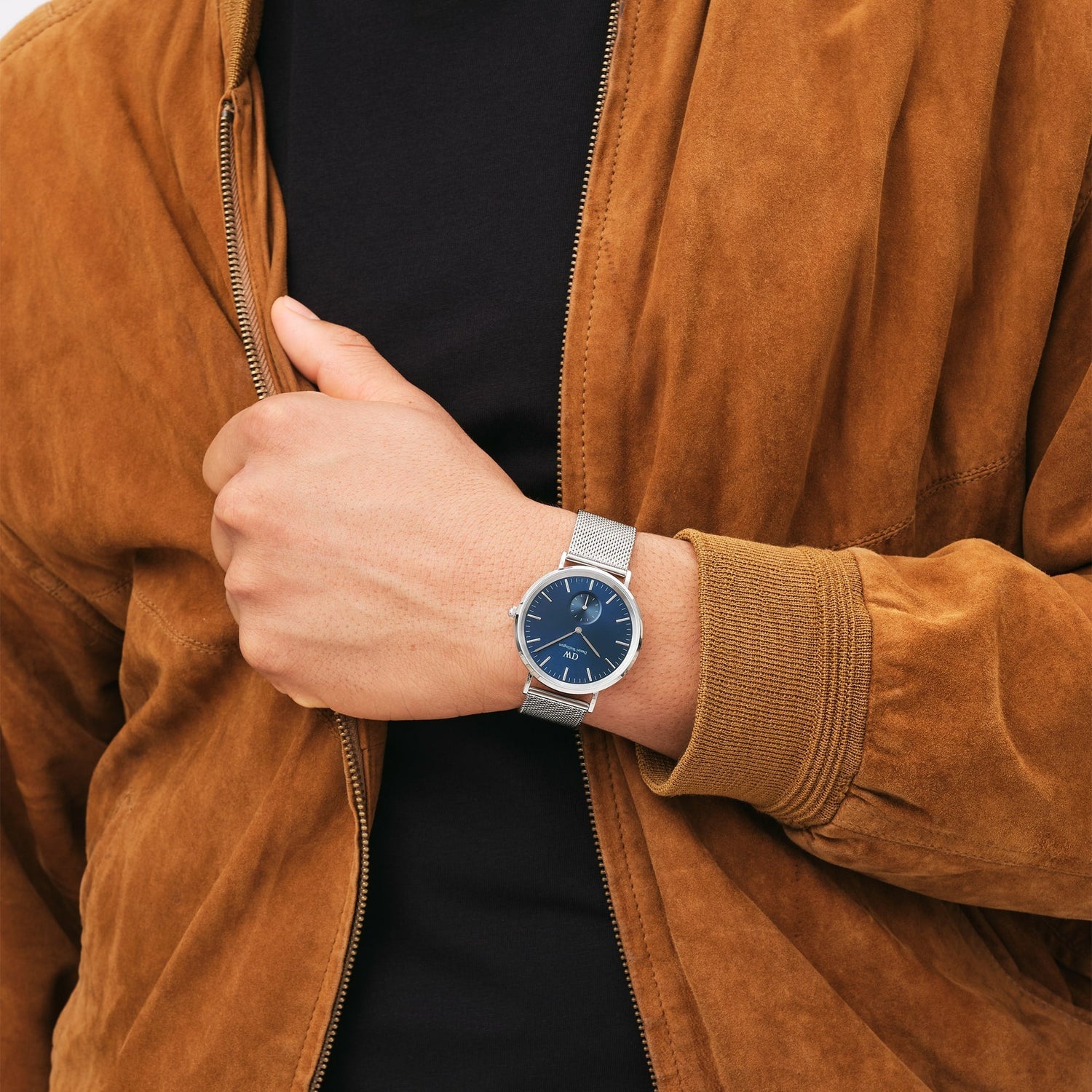 Wristwatch with a blue face and silver metal band.