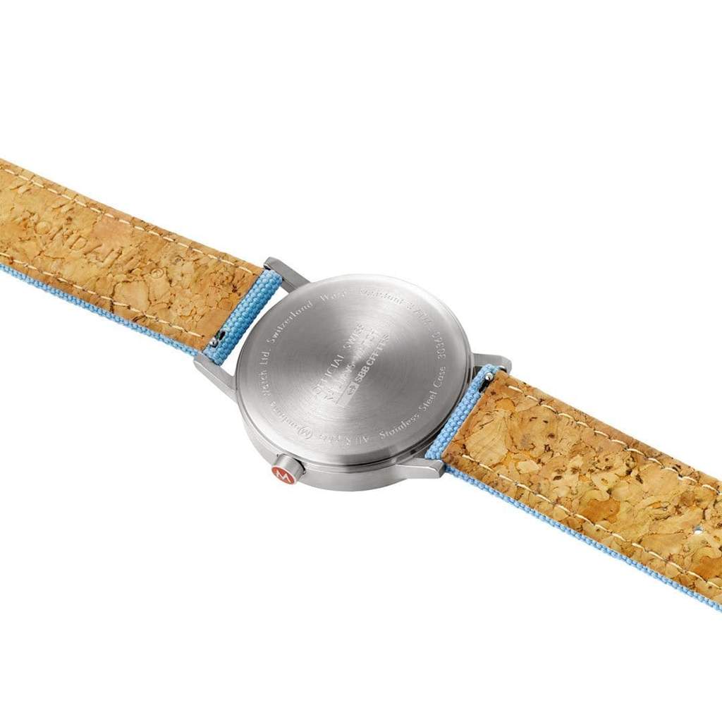 Wristwatch with a silver case and cork-textured strap.