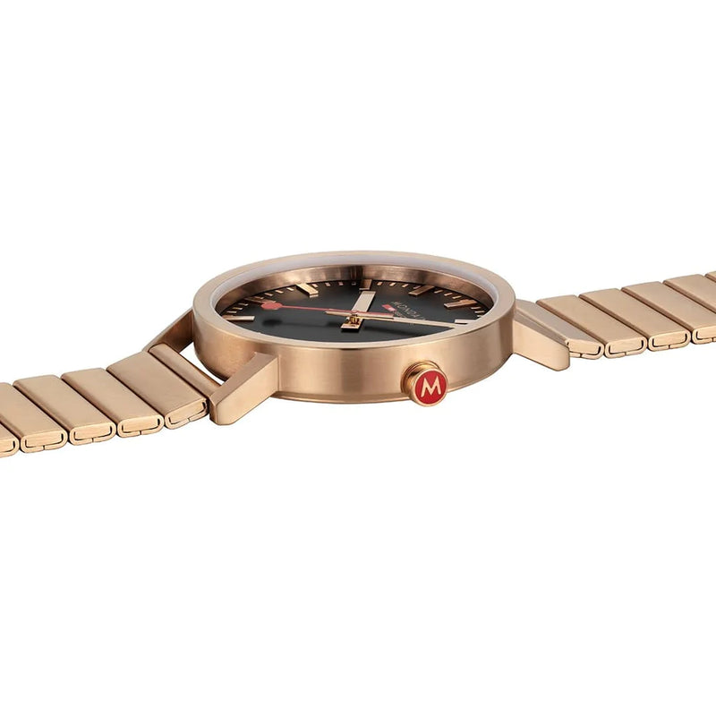 Rose gold wristwatch with a sleek metal band and black dial face.