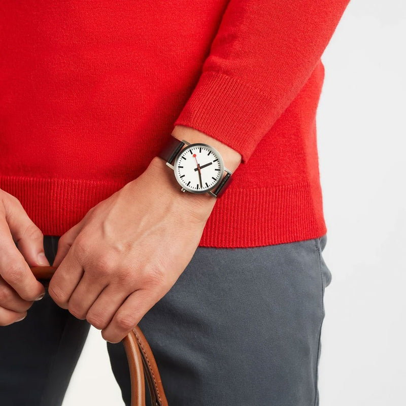 Wristwatch with a white face and black leather strap.