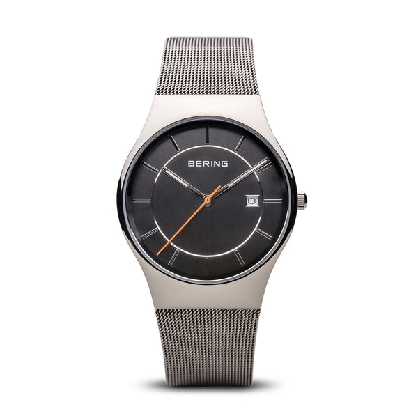 Sleek silver wristwatch with a black dial and mesh metal band.