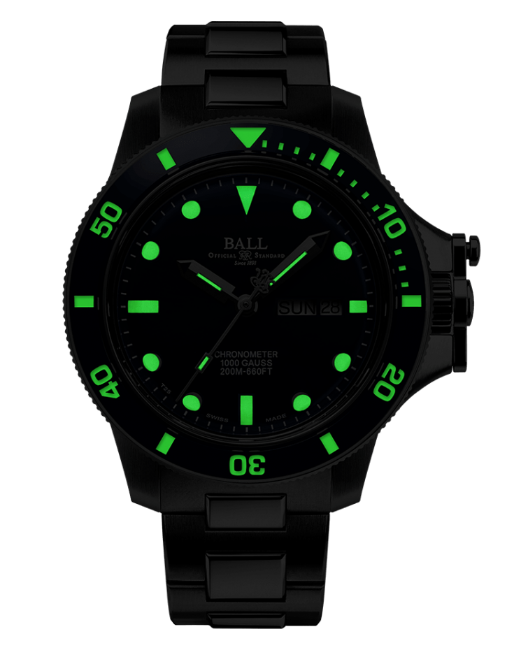 Black wristwatch with glowing green markings on the face and bezel.