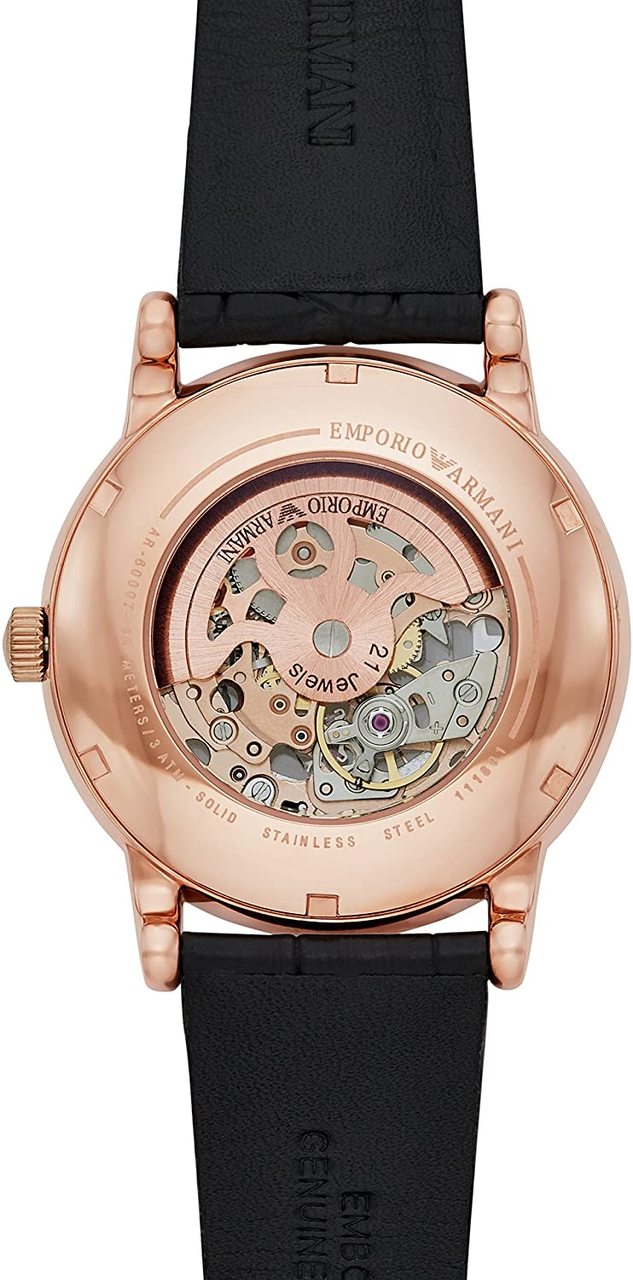 Back of a rose gold wristwatch with a visible mechanical movement through a transparent case back.