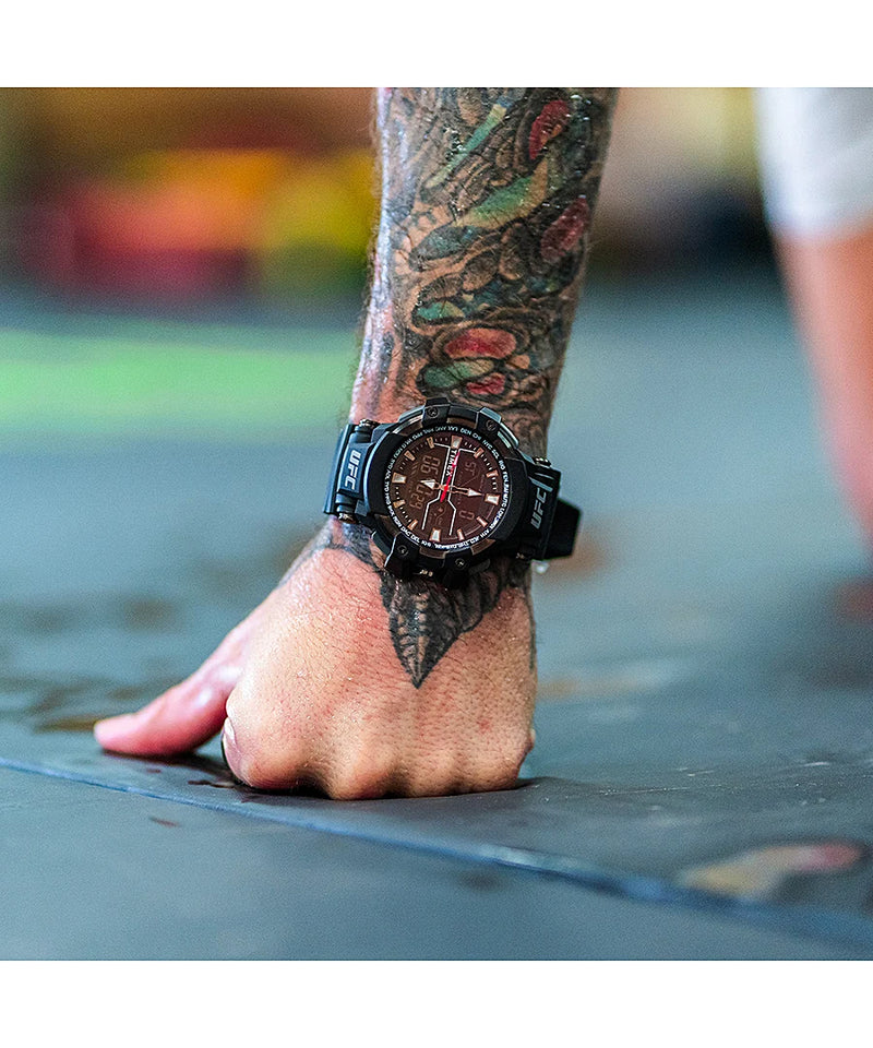 Wristwatch worn on a heavily tattooed arm.