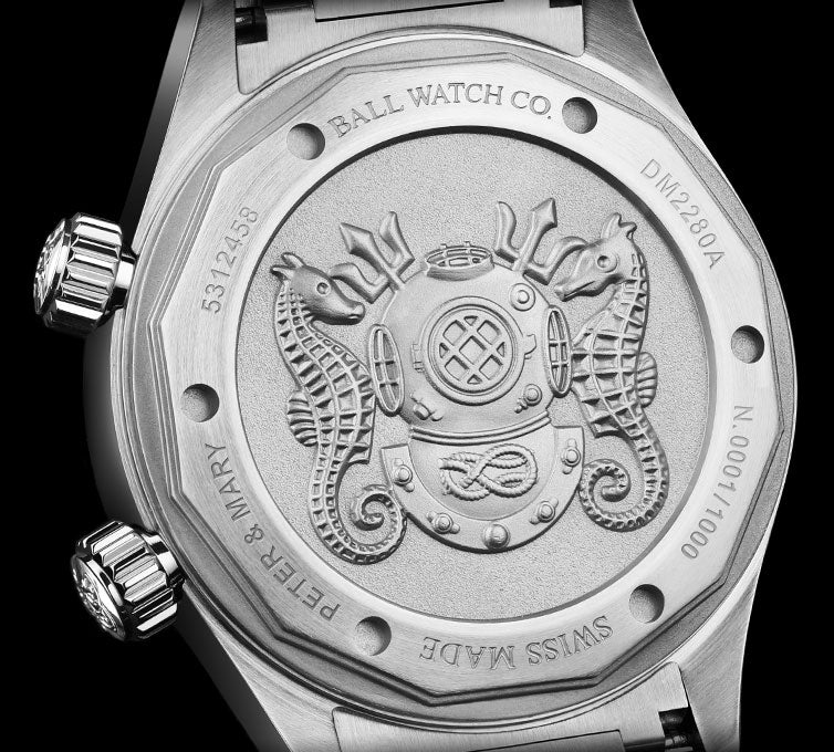Back of a luxury watch case featuring an engraved diving helmet design.