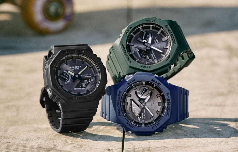 Three rugged sports watches in black, green, and blue colors.