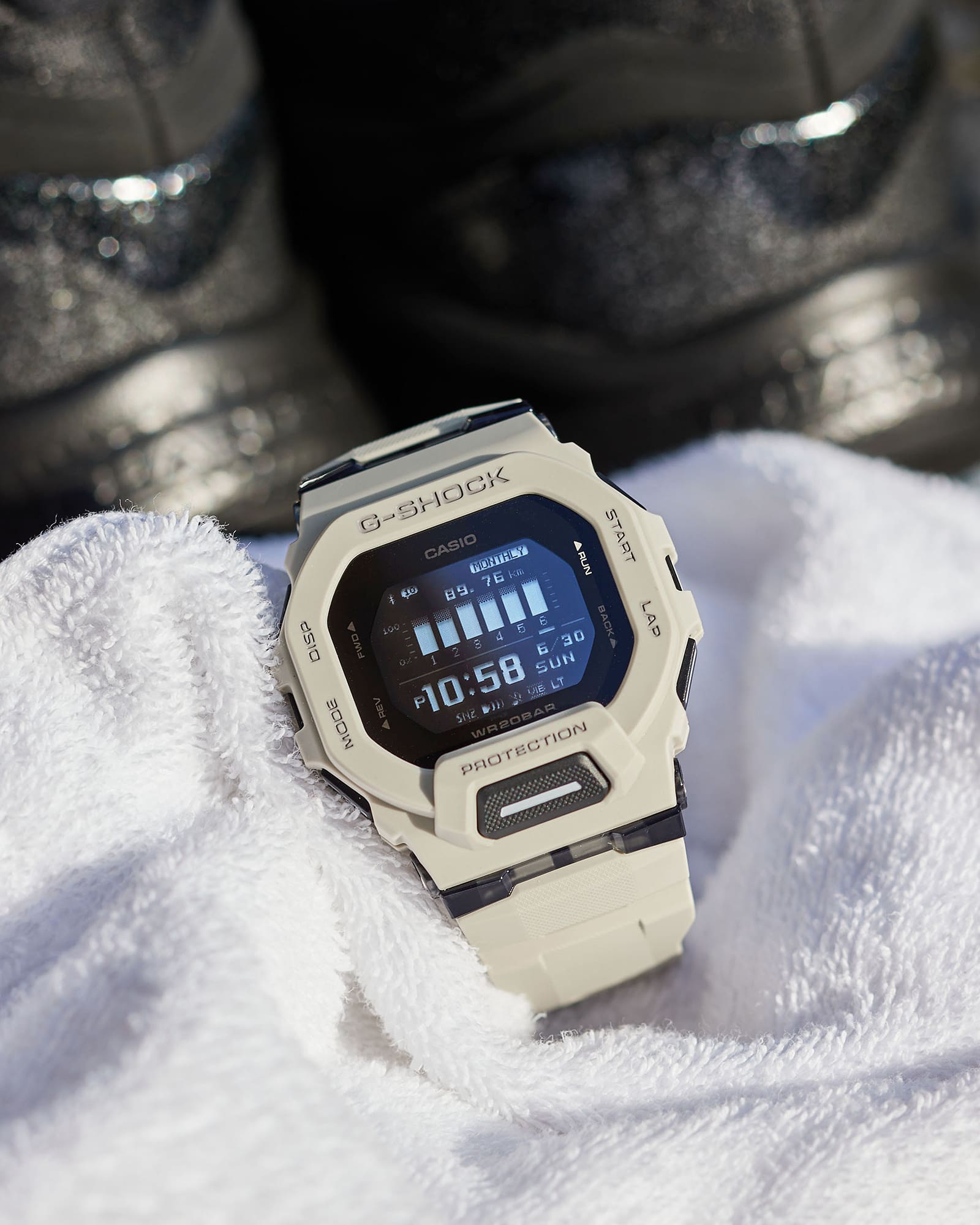 White G-Shock digital watch with a square face displaying the time 10:58.