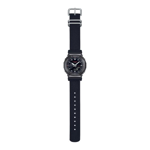 Black digital wristwatch with a round face and fabric strap.