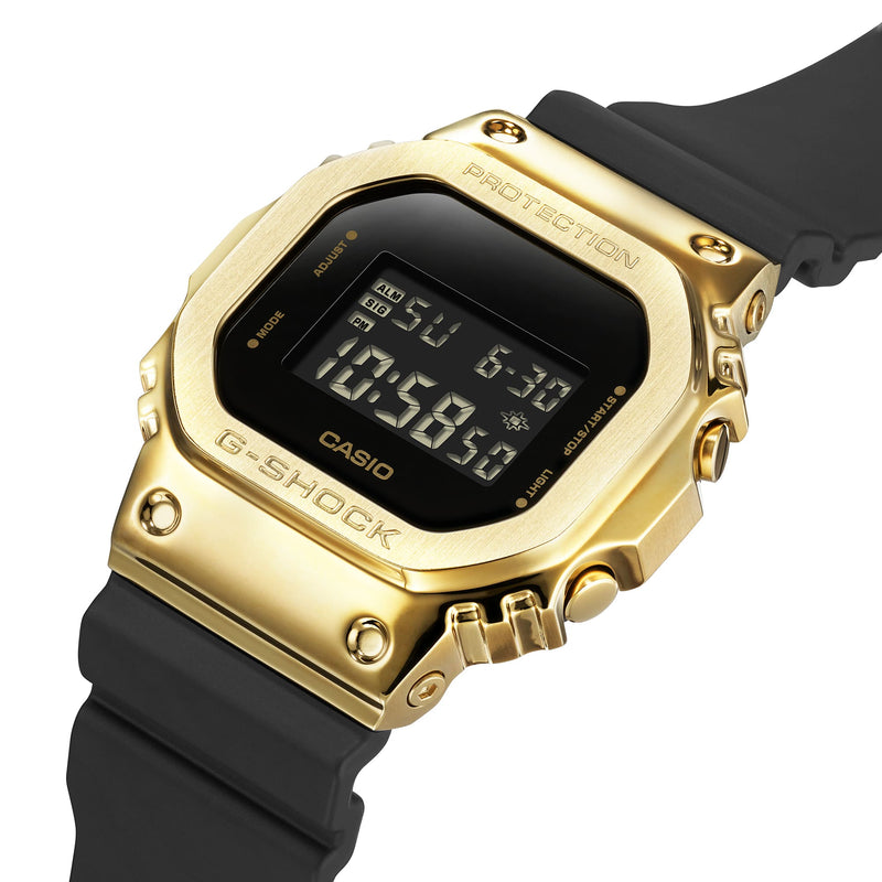 Gold-toned digital Casio G-Shock watch with a black resin strap.