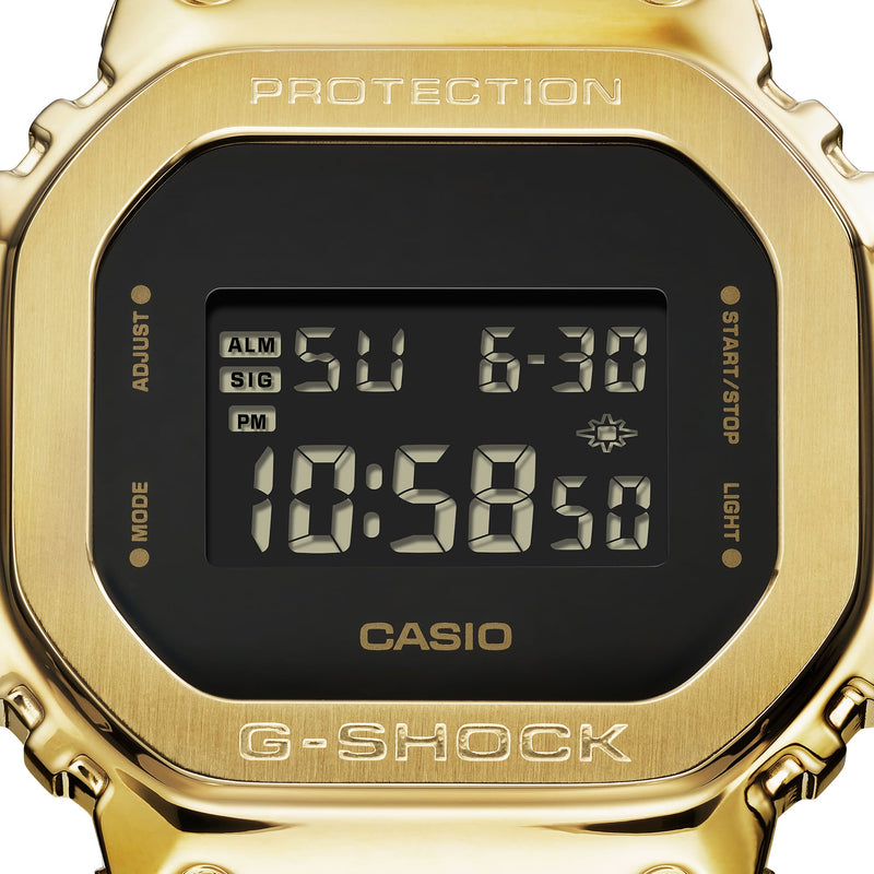 Gold-colored Casio G-Shock digital watch with a square face displaying the time.