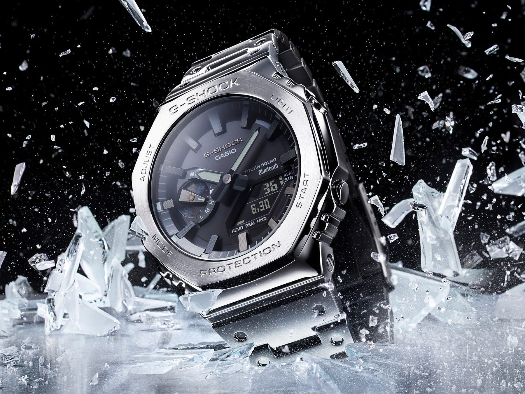 Metallic wristwatch surrounded by shattered ice fragments.