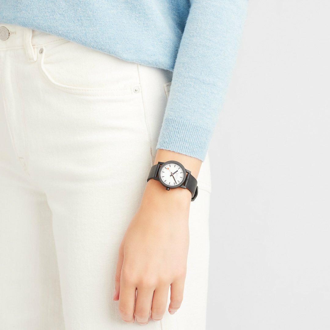 Wristwatch with a black strap and round white face.