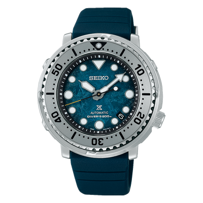 Seiko dive watch with a teal dial and silver bezel on a blue rubber strap.