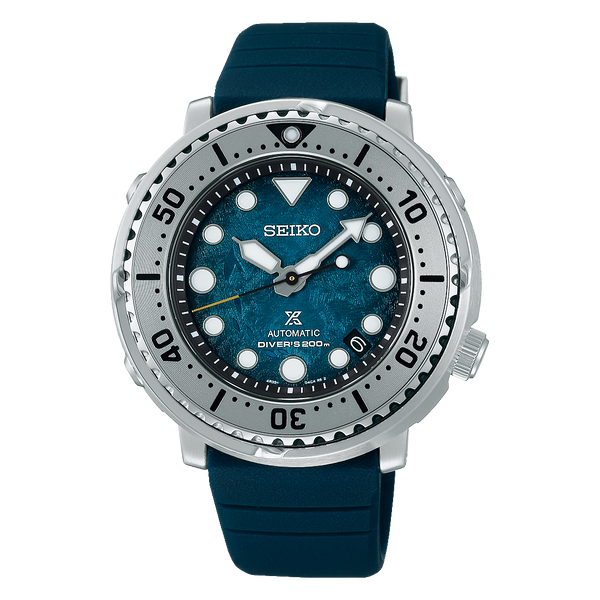 Seiko dive watch with a teal dial and silver bezel on a blue rubber strap.