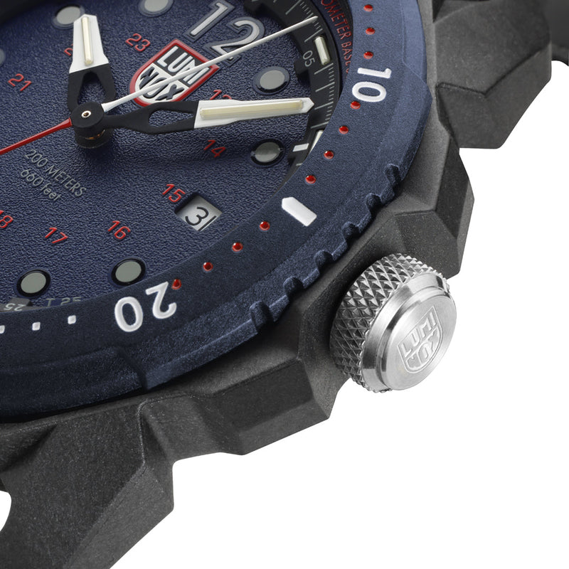 Wristwatch with a dark blue face and red accents on the dial.