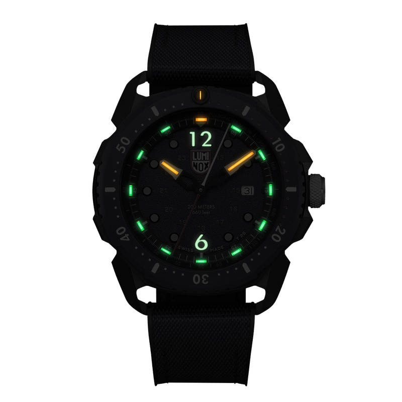 Black wristwatch with glowing green and orange markers on the dial.