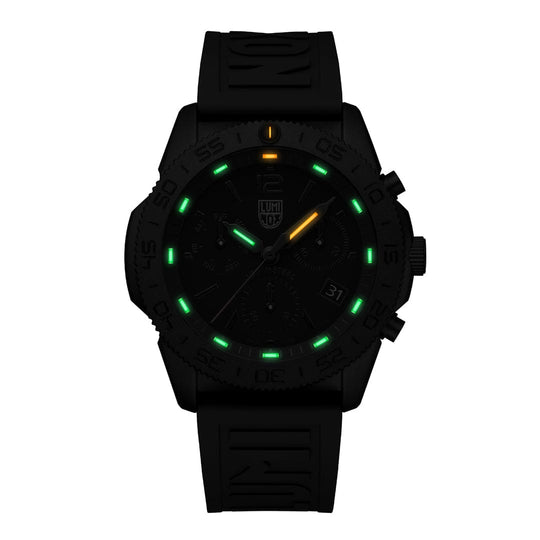 Black wristwatch with glowing green and yellow markers on the dial.