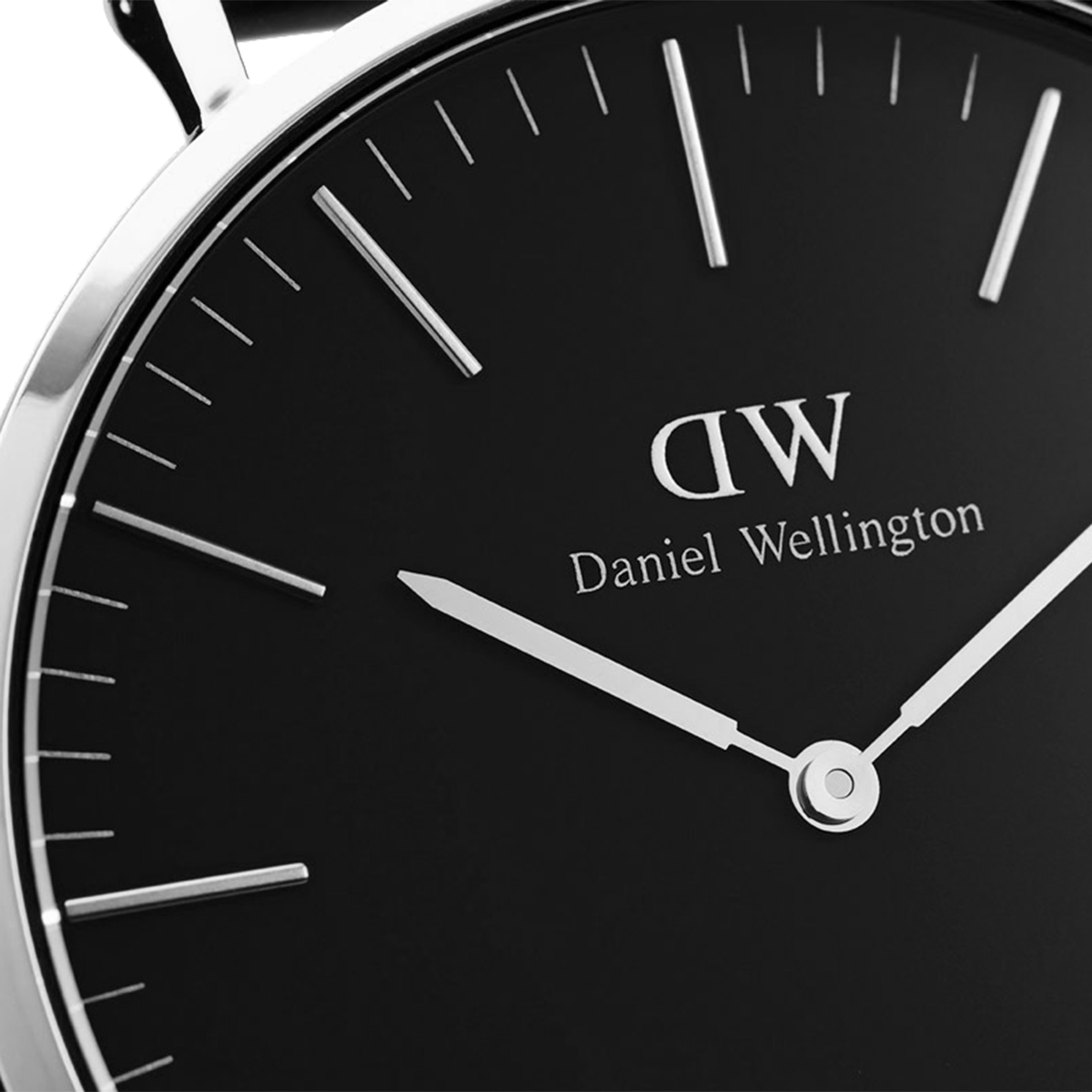 Sleek black-faced wristwatch with white hands and markings, displaying the Daniel Wellington brand.