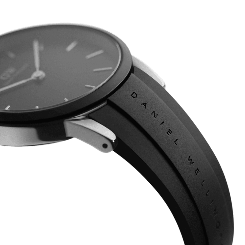 Sleek black wristwatch with a minimalist analog face and leather strap.