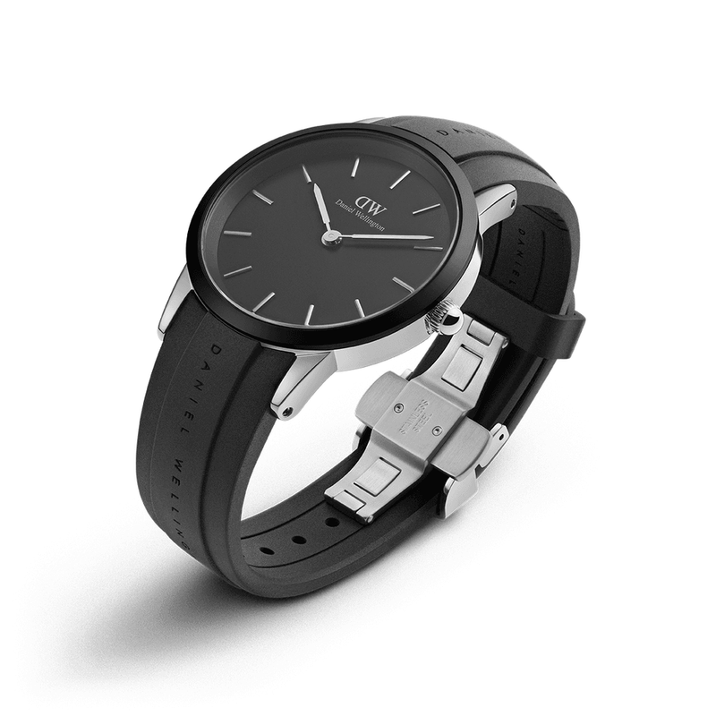 Sleek black wristwatch with a round face and leather strap.